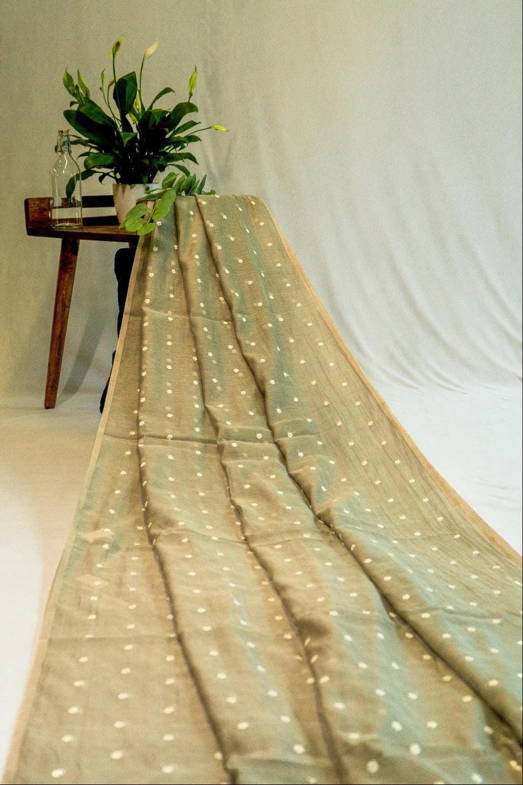 Lighted fabric draped over a table with a white background